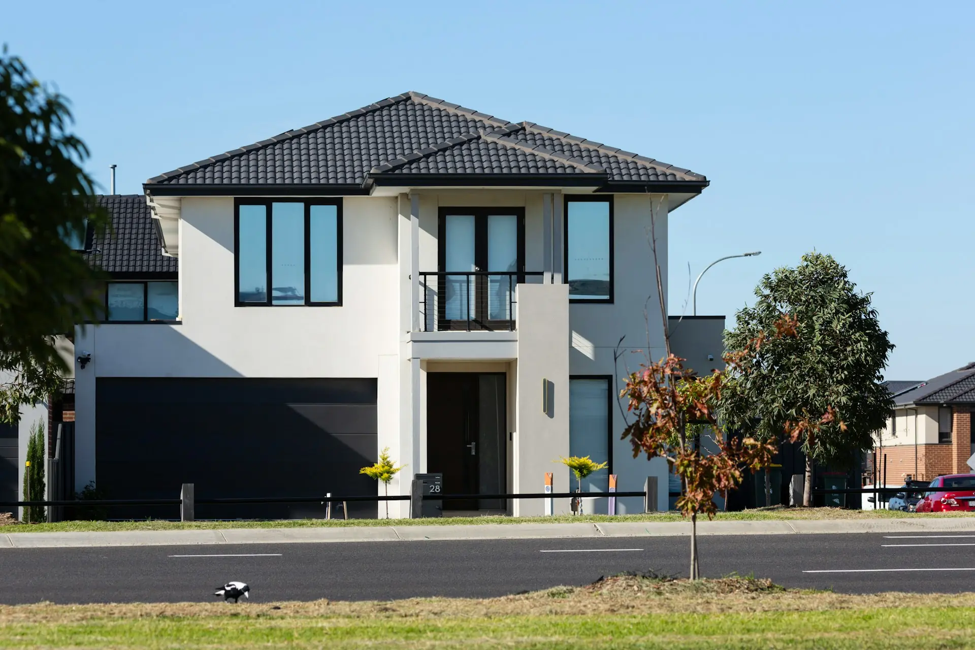 Two-story home with a dark two-car garage door