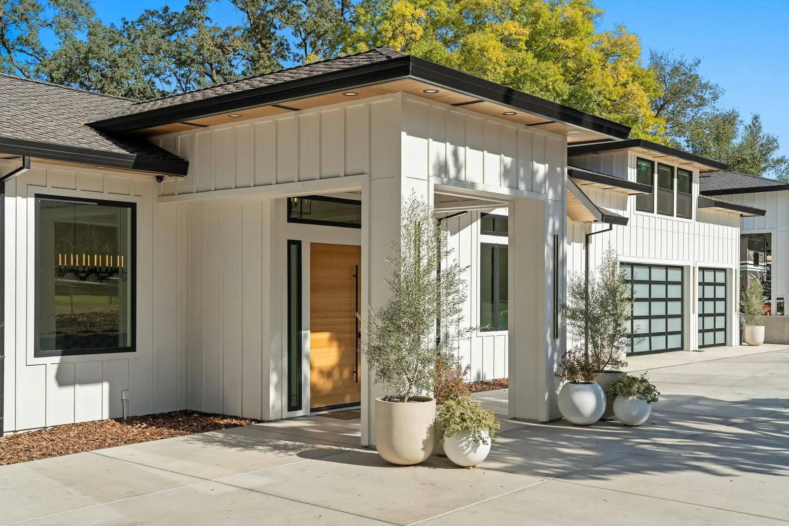 Modern white home with a glass-paneled garage door