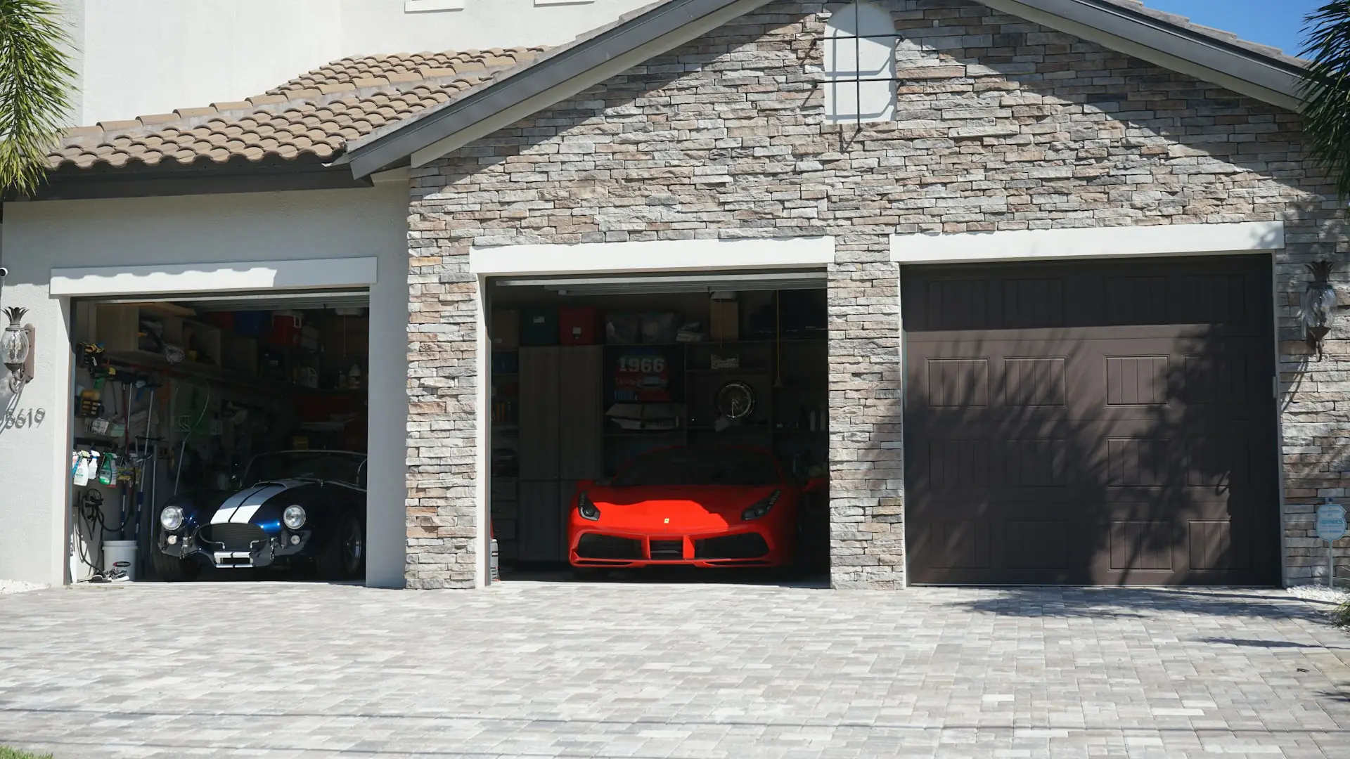 Open garage with a car inside, next to a closed garage door